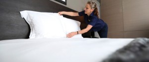 A chambermaid makes a bed in a room at D&D London Ltd's South Place hotel in London, U.K., on Thursday, Sept. 13, 2012. London hotels' average room rates rose 87 percent for the Olympic Games and hoteliers reported a slight occupancy increase, according to data compiled by hotel industry researcher STR Global. Photographer: Chris Ratcliffe/Bloomberg via Getty Images